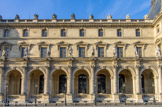 <center>La Cour Napoléon. </center>Entre les pavillons Mollien et Denon, de gauche à droite, Poussin, François Rude. Audran,  Jacques Léonard Maillet. Sarrazin, Honoré Husson. Coustou, Augustin Courtet. Lesueur, Honoré Husson. Perrault, Auguste Hyacinthe De Bay. Champaigne, Louis Alphonse Eudes. Puget, Antoine Etex